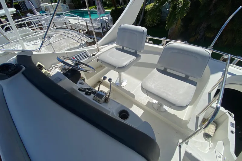 Slide: The Image of 2006 Carver 33 Super Sport boat cockpit with dual seats and steering controls. - 21