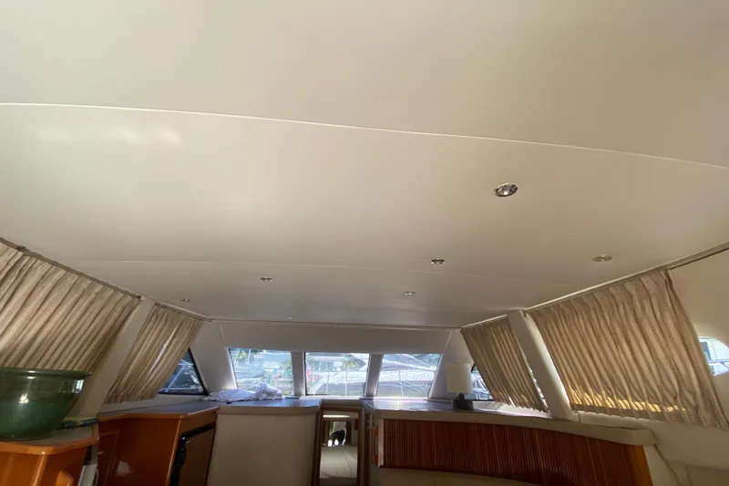 Slide: The Image of Interior of 2006 Carver 33 Super Sport yacht with curtains and ceiling lights. - 25