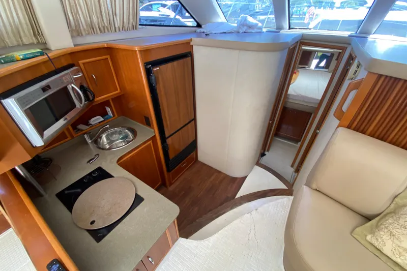 Slide: The Image of 2006 Carver 33 Super Sport yacht interior with kitchen and cozy cabin. - 26