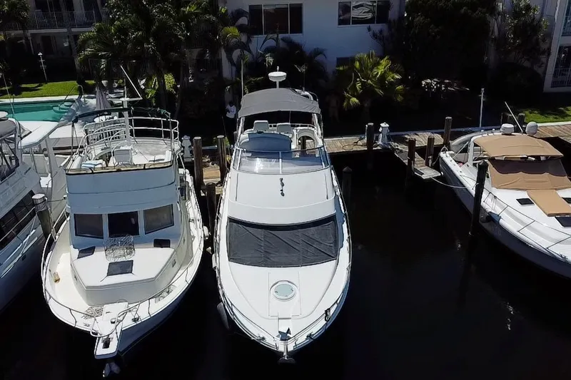 Slide: The Image of 2006 Carver 33 Super Sport yacht docked between two boats. - 6