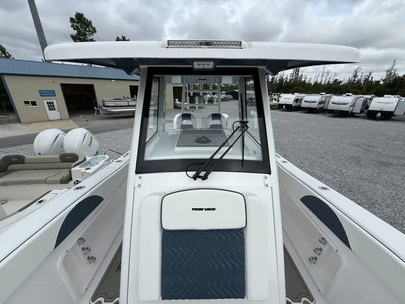 Slide: The Image of 2026 Twin Vee GFX2 260 boat at a dealership with trailers in the background. - 10