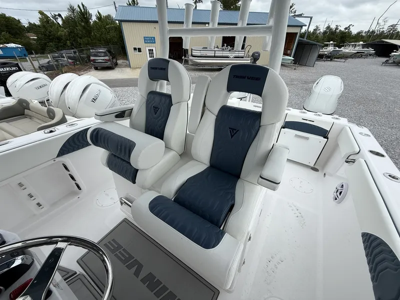 Slide: The Image of 2026 Twin Vee GFX2 260 boat interior with dual captain's chairs and Yamaha engines. - 11