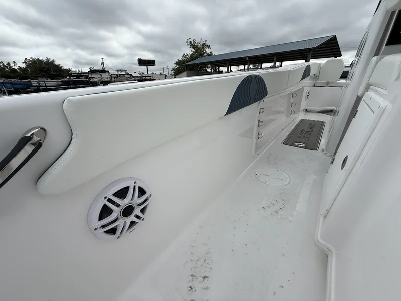 Slide: The Image of 2026 Twin Vee GFX2 260 boat interior with speaker and storage compartments. - 13