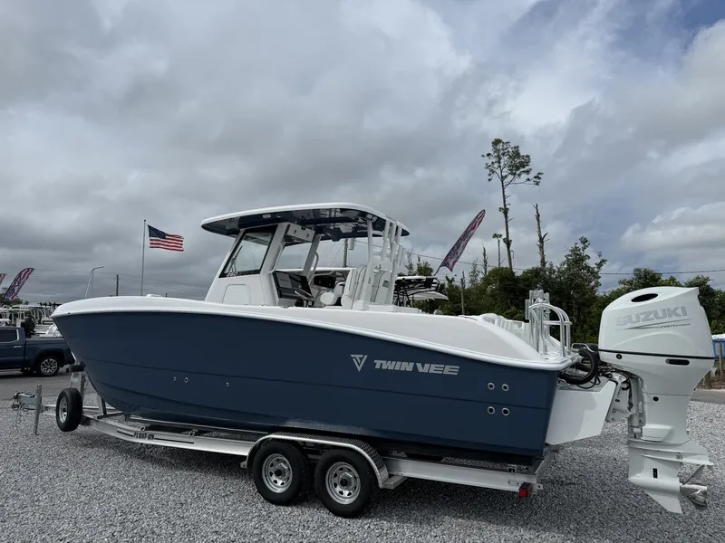Slide: The Image of 2026 Twin Vee GFX2 260 boat on trailer with Suzuki outboard motor. - 2