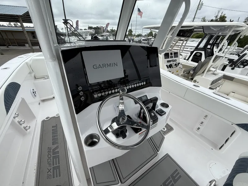 Slide: The Image of 2026 Twin Vee GFX2 260 boat cockpit with Garmin navigation system and sleek steering wheel. - 6
