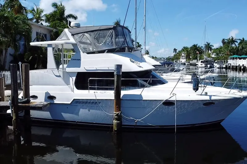 The Image of 2003 Carver 356 Motor Yacht docked in a sunny marina setting. - 1