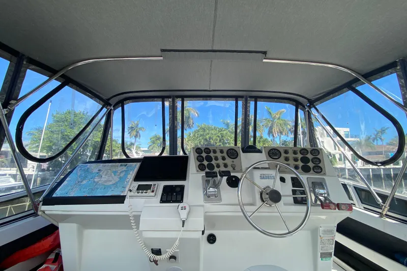 Slide: The Image of 2003 Carver 356 Motor Yacht helm with navigation equipment and steering wheel. - 16