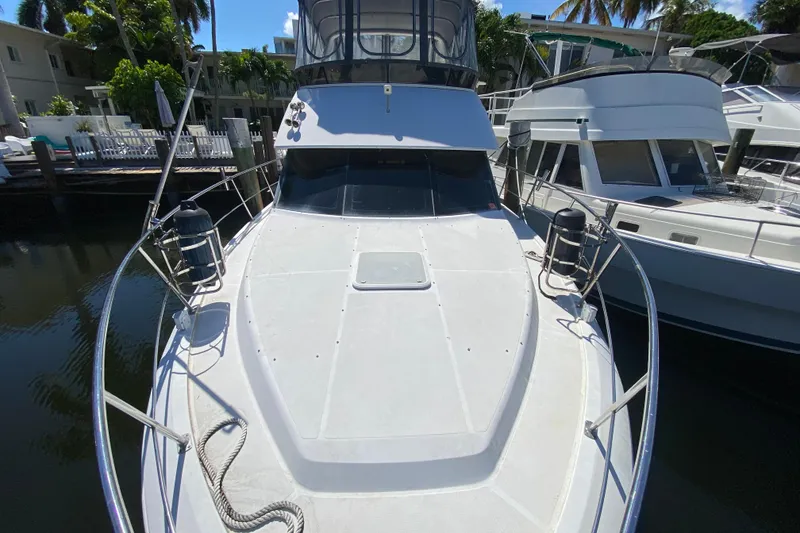 Slide: The Image of 2003 Carver 356 Motor Yacht docked, showcasing spacious deck and sleek design. - 8
