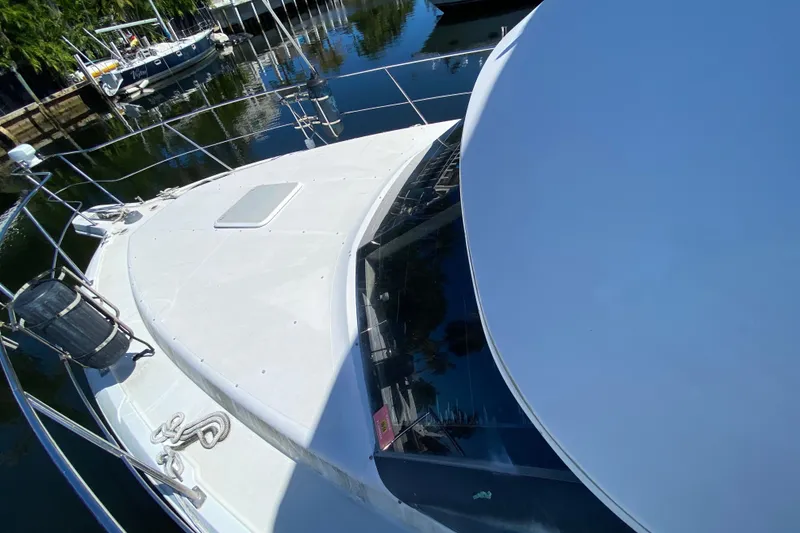 Slide: The Image of 2003 Carver 356 Motor Yacht docked, showcasing sleek design and spacious deck. - 10