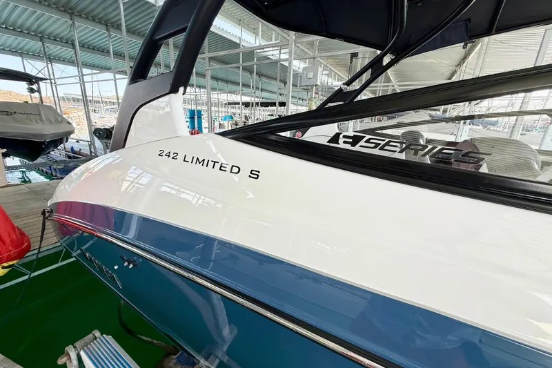 Slide: The Image of 2018 Yamaha Boats 242 Limited S E-Series docked in a marina. - 12