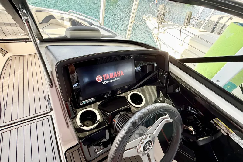 Slide: The Image of 2018 Yamaha Boats 242 Limited S E-Series dashboard with steering wheel and display screen. - 28