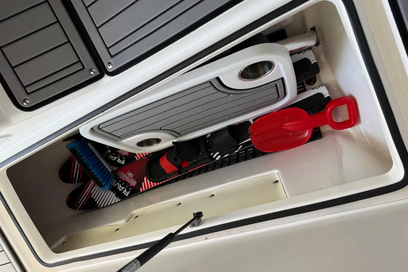 Slide: The Image of Storage compartment in 2018 Yamaha Boats 242 Limited S E-Series with water skis and accessories. - 39