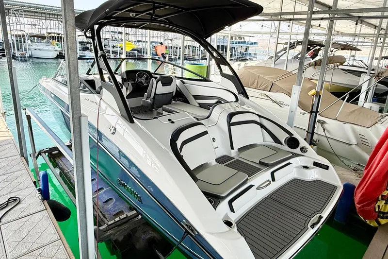 Slide: The Image of 2018 Yamaha Boats 242 Limited S E-Series docked in a marina, showcasing sleek design. - 4