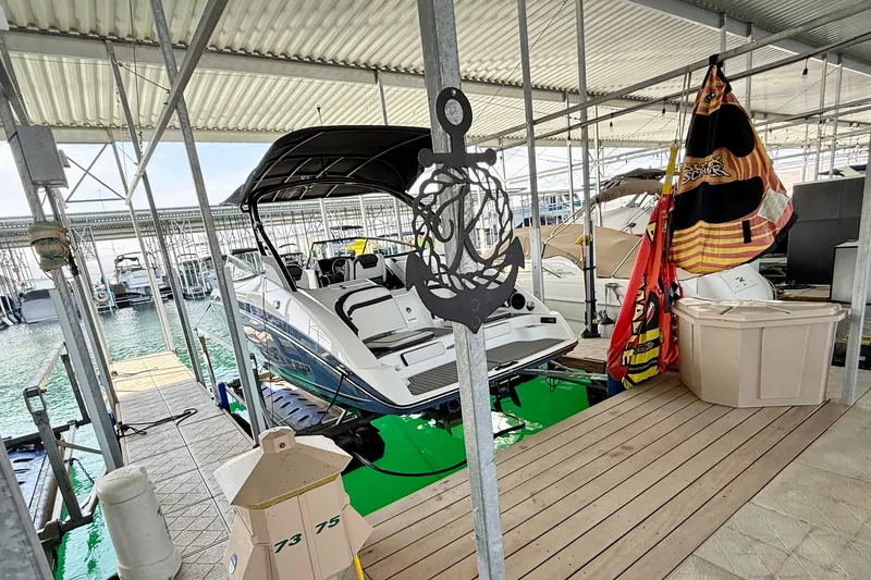 Slide: The Image of 2018 Yamaha Boats 242 Limited S E-Series docked in a marina with nautical decor. - 40