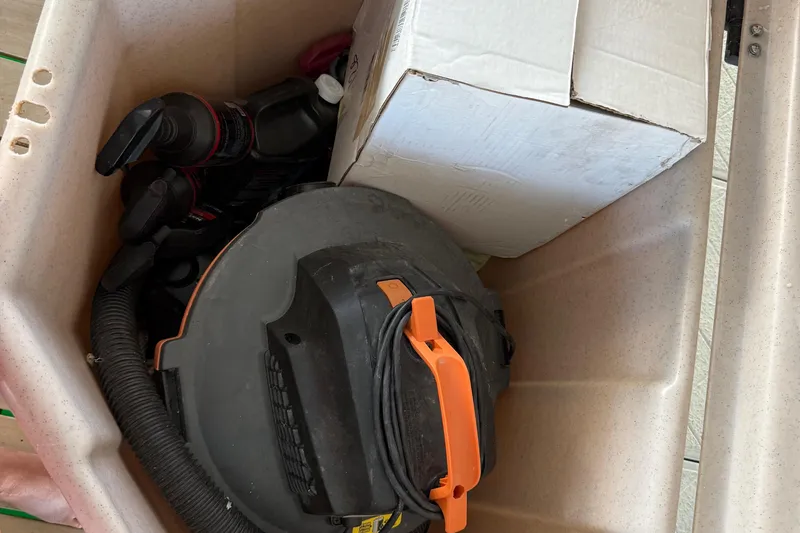 Slide: The Image of Storage compartment of 2018 Yamaha Boats 242 Limited S E-Series with cleaning supplies. - 42