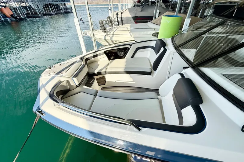 Slide: The Image of 2018 Yamaha Boats 242 Limited S E-Series with spacious seating in marina. - 6