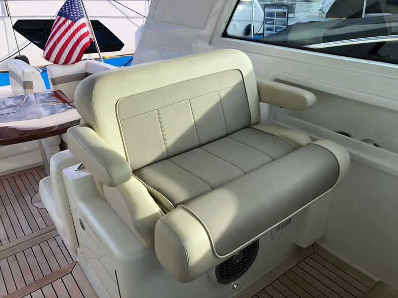 Slide: The Image of Captain's seat on 2012 Sea Ray 450 Sundancer yacht, with American flag in background. - 11