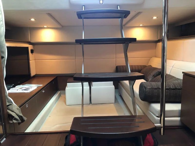 Slide: The Image of Interior of 2012 Sea Ray 450 Sundancer yacht with modern seating and wooden steps. - 14