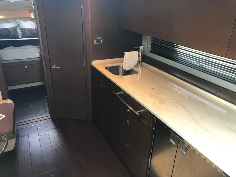 Slide: The Image of Luxurious interior of 2012 Sea Ray 450 Sundancer yacht with modern kitchen amenities. - 16