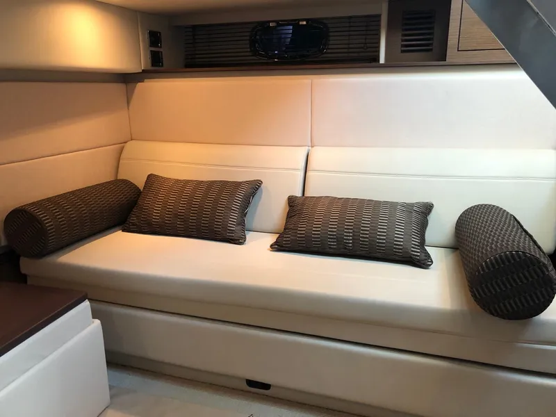 Slide: The Image of Luxurious interior of 2012 Sea Ray 450 Sundancer with plush seating and cushions. - 17