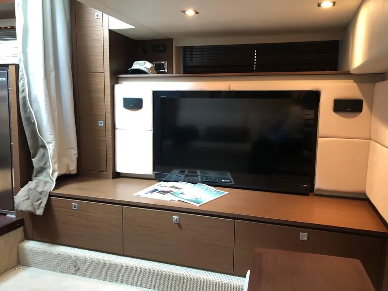 Slide: The Image of Luxurious interior of 2012 Sea Ray 450 Sundancer with TV and modern cabinetry. - 18