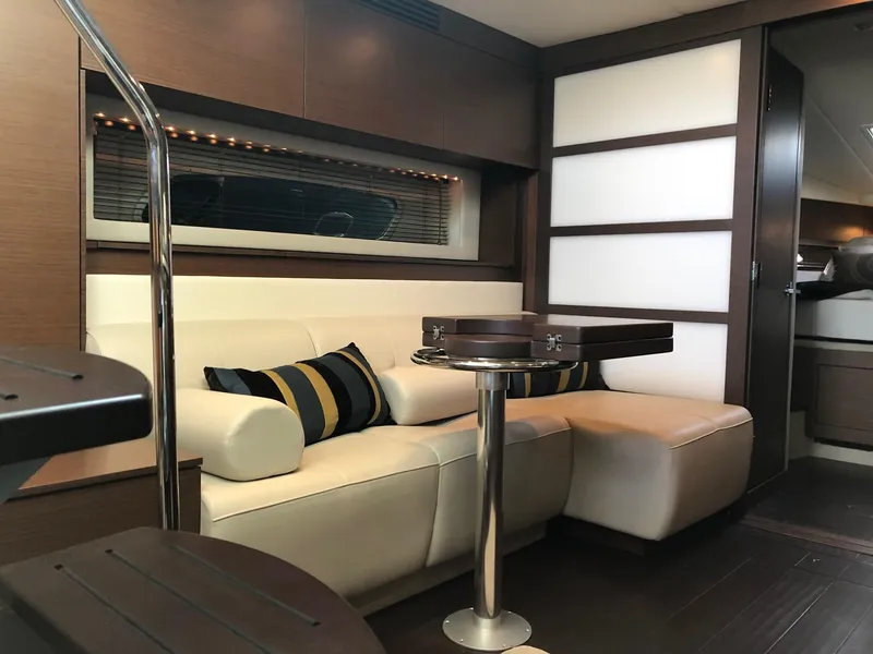 Slide: The Image of Luxurious interior of 2012 Sea Ray 450 Sundancer yacht with modern seating and table. - 19