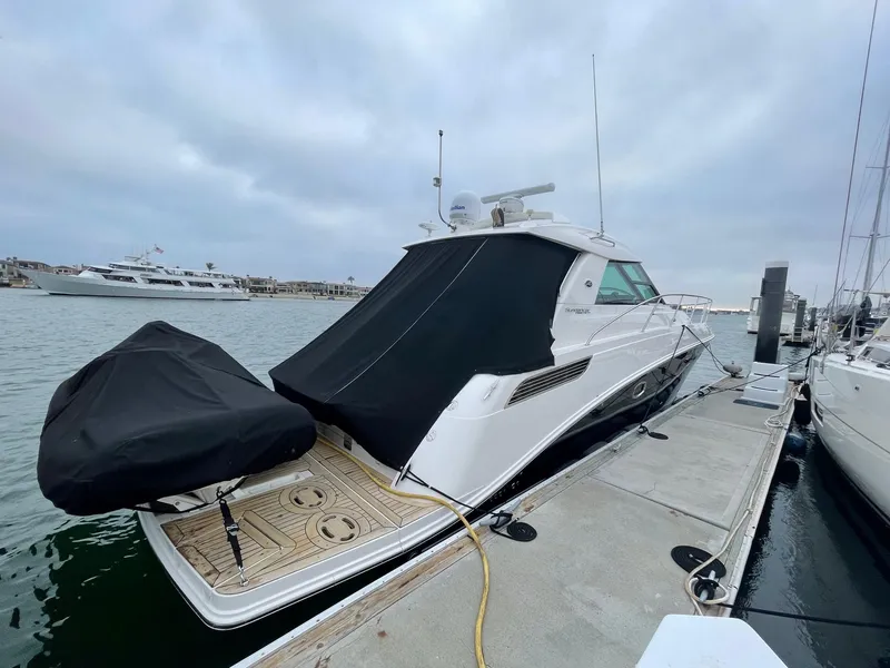 Slide: The Image of 2012 Sea Ray 450 Sundancer yacht docked at marina, covered and ready for use. - 2