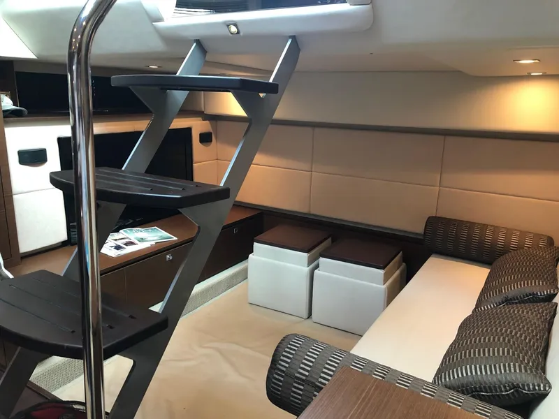 Slide: The Image of Interior of 2012 Sea Ray 450 Sundancer yacht, featuring modern seating and sleek design. - 20