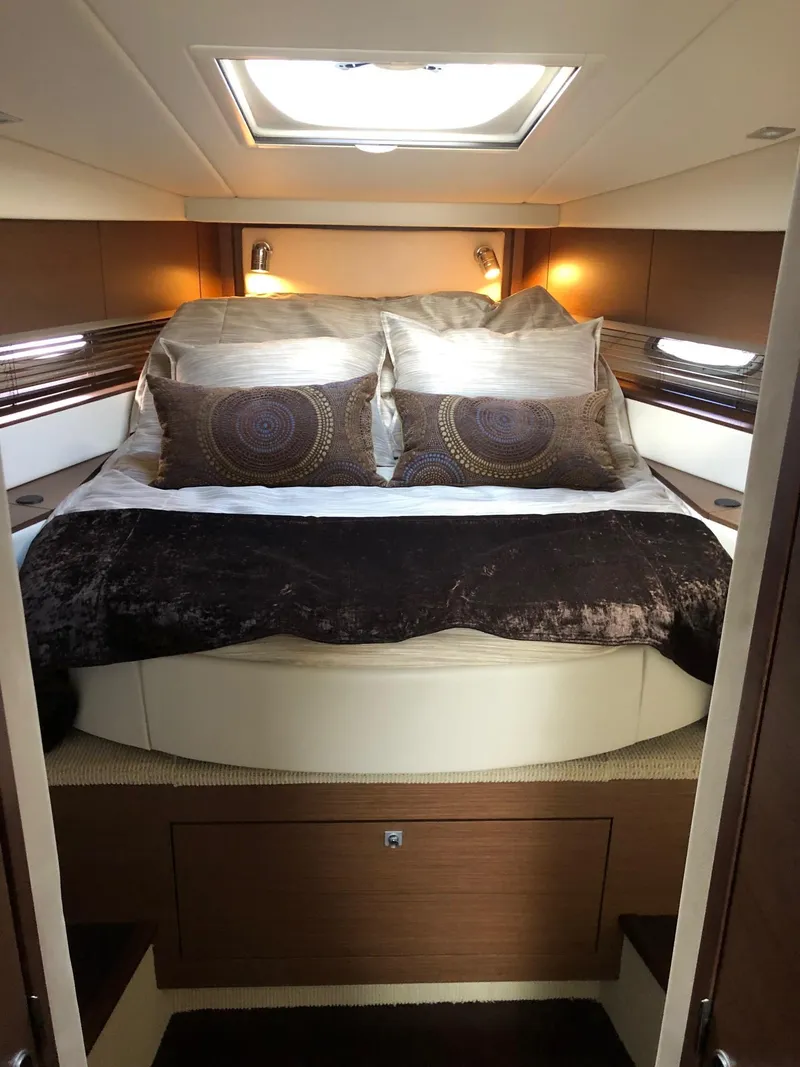 Slide: The Image of Luxurious cabin interior of 2012 Sea Ray 450 Sundancer yacht with elegant bedding. - 21