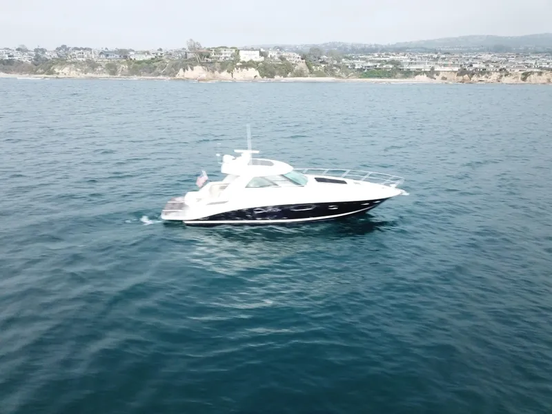 Slide: The Image of 2012 Sea Ray 450 Sundancer yacht cruising on open water. - 24