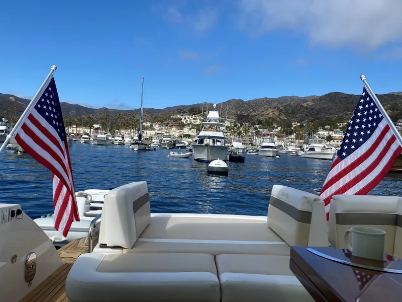 Slide: The Image of Sea Ray 450 Sundancer 2012 yacht with American flags in a scenic marina. - 5
