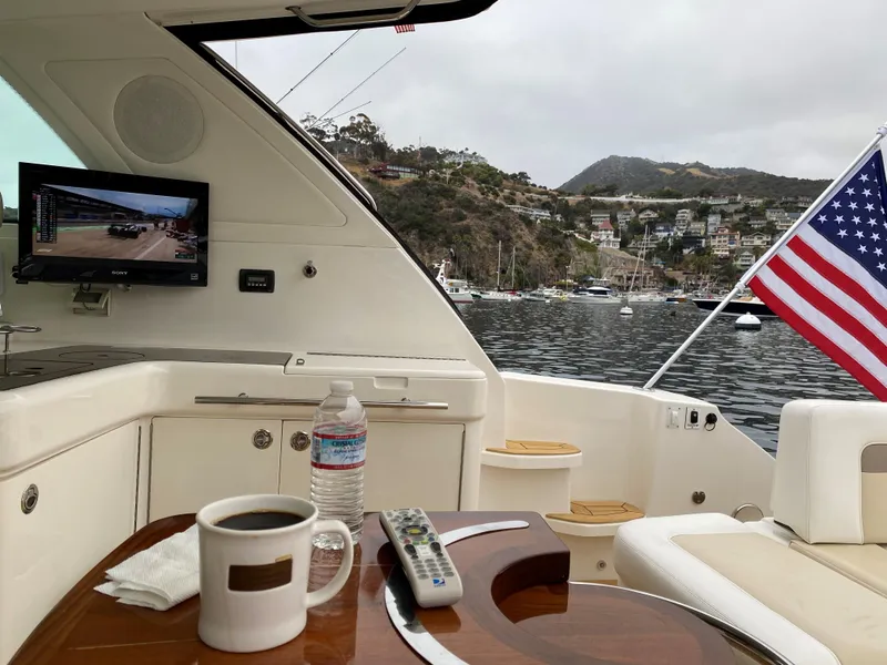 Slide: The Image of Luxurious 2012 Sea Ray 450 Sundancer yacht interior with coffee, TV, and American flag. - 6