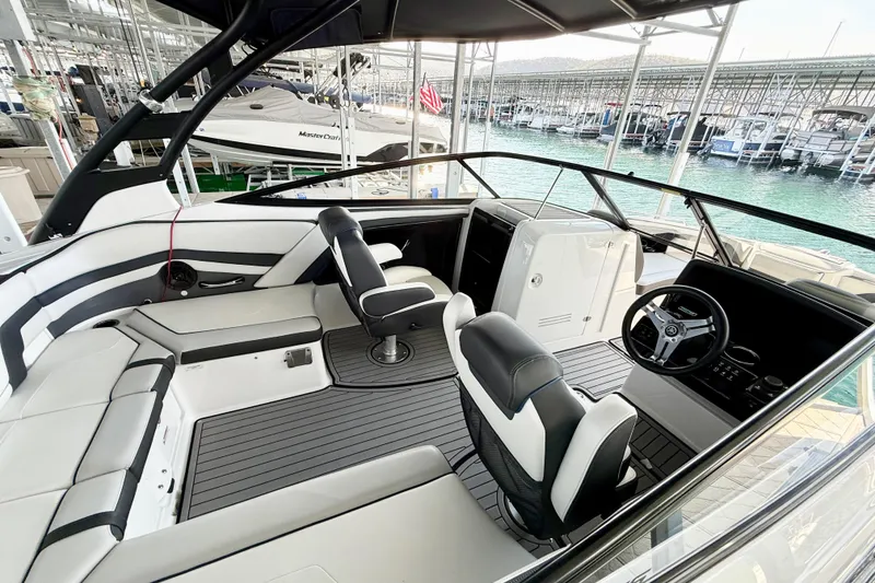 Slide: The Image of 2018 Yamaha Boats 242 Limited S E-Series interior with sleek seating and modern dashboard. - 13