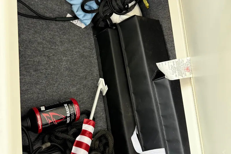 Slide: The Image of Storage compartment of 2018 Yamaha 242 Limited S E-Series with boating accessories. - 20