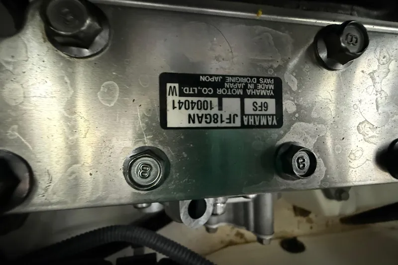 Slide: The Image of Close-up of Yamaha 242 Limited S E-Series engine part with label and bolts. - 22