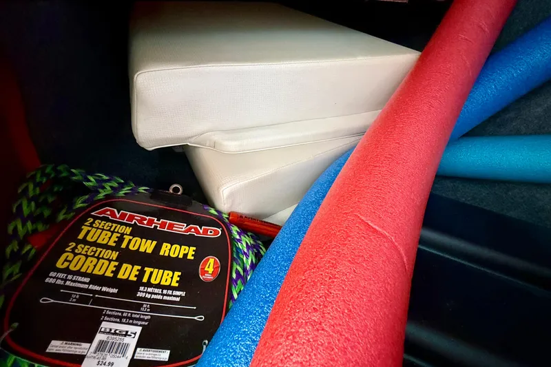 Slide: The Image of Storage compartment of 2018 Yamaha 242 Limited S E-Series with tow rope and pool noodles. - 31