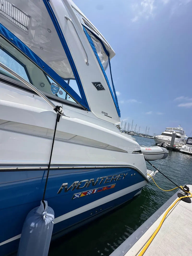 Slide: The Image of 2020 Monterey 355 Sport Yacht docked at marina under clear blue sky. - 12