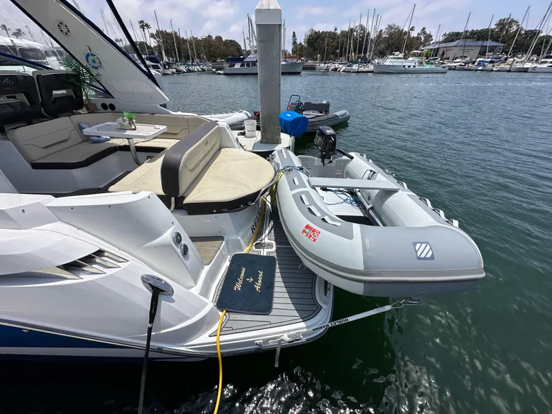 Slide: The Image of 2020 Monterey 355 Sport Yacht docked with inflatable boat, marina background. - 14