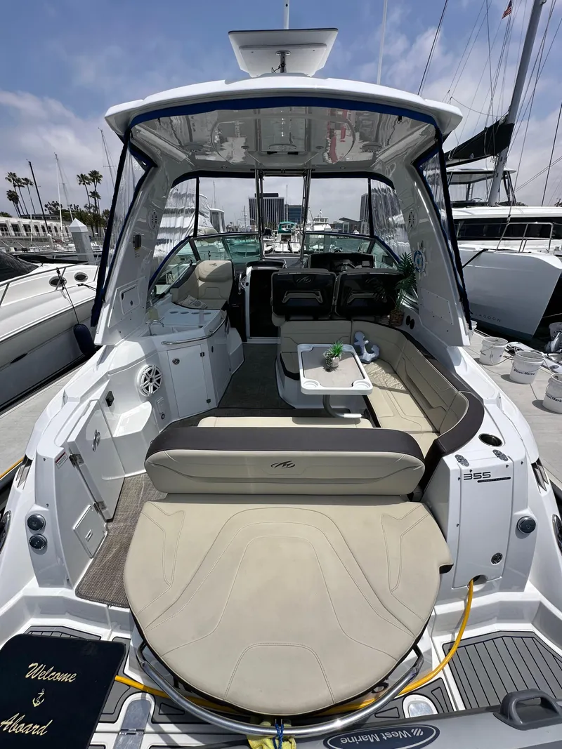 Slide: The Image of 2020 Monterey 355 Sport Yacht with spacious seating and modern interior at a marina. - 20