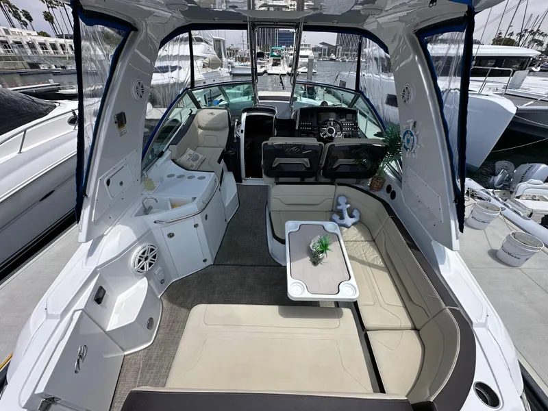 Slide: The Image of Interior of a 2020 Monterey 355 Sport Yacht with seating and table. - 21
