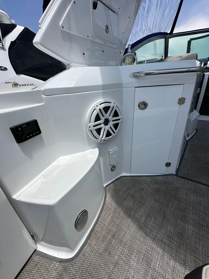Slide: The Image of 2020 Monterey 355 Sport Yacht interior with speaker, storage, and seating area. - 23