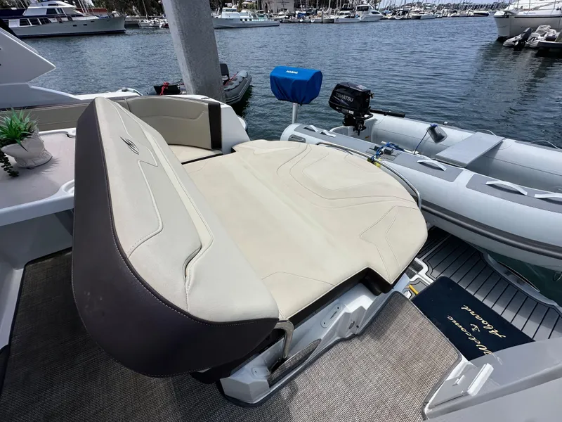 Slide: The Image of 2020 Monterey 355 Sport Yacht with beige seating, docked at a marina. - 24