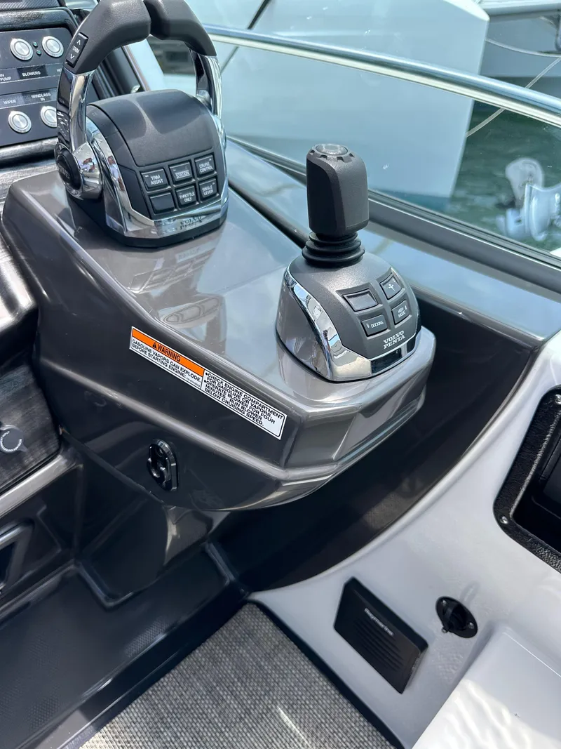 Slide: The Image of 2020 Monterey 355 Sport Yacht helm controls with joystick and throttle levers. - 36