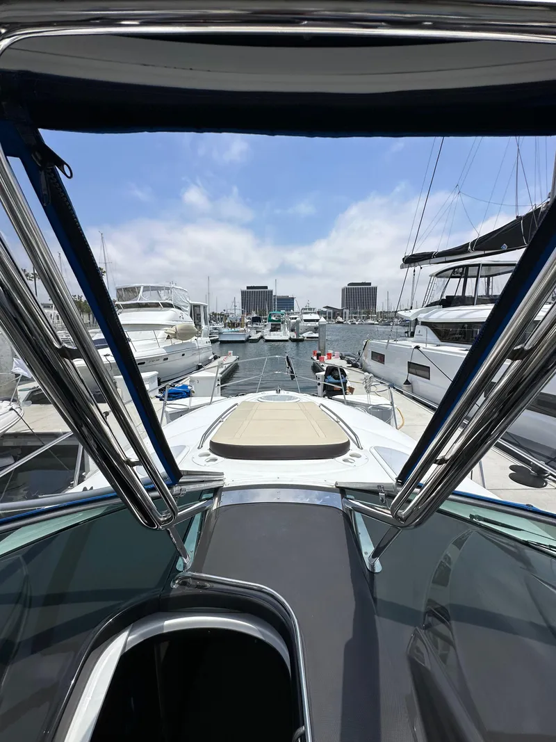Slide: The Image of 2020 Monterey 355 Sport Yacht docked in a marina, surrounded by other boats. - 39