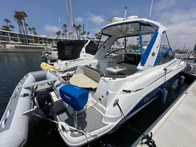 Slide: The Image of 2020 Monterey 355 Sport Yacht docked at marina with inflatable boat attached. - 4