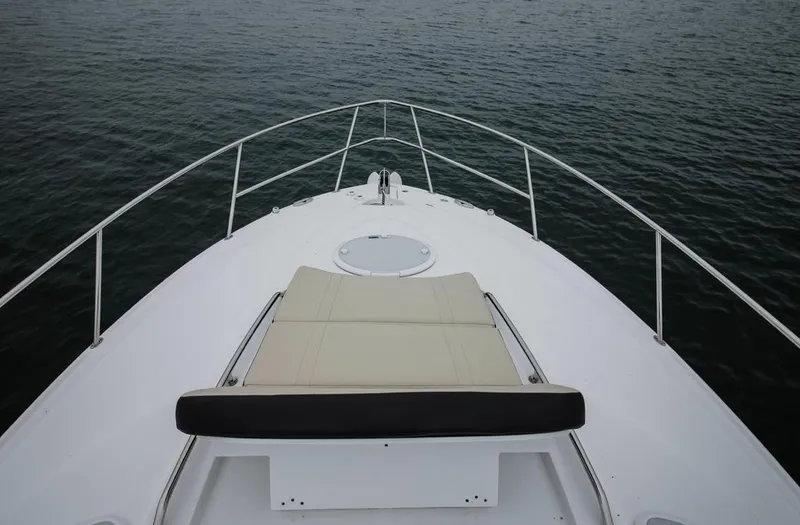 Slide: The Image of 2020 Monterey 355 Sport Yacht bow view with sun pad, on calm water. - 40