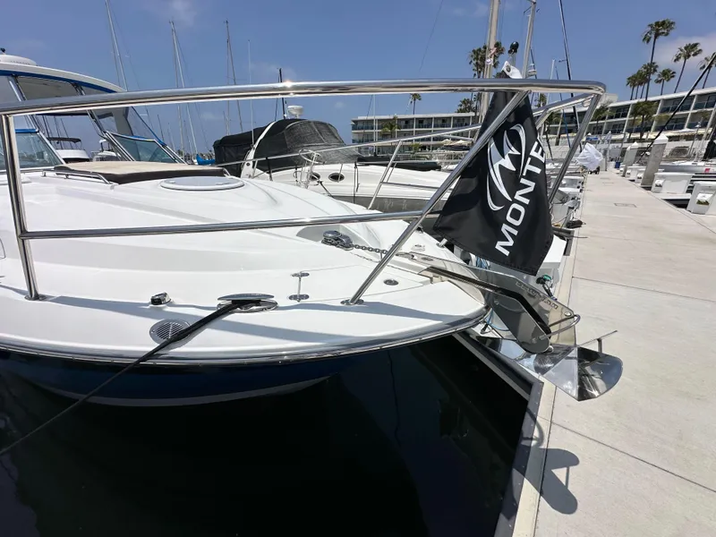 Slide: The Image of 2020 Monterey 355 Sport Yacht docked at marina with flag and anchor. - 7