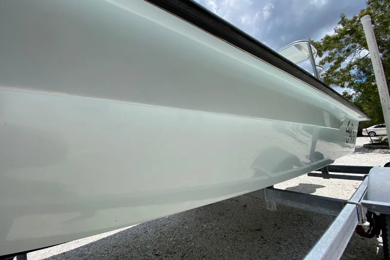 Slide: The Image of 2019 Cayo Boatworks 173 on trailer, sleek hull design under cloudy sky. - 10