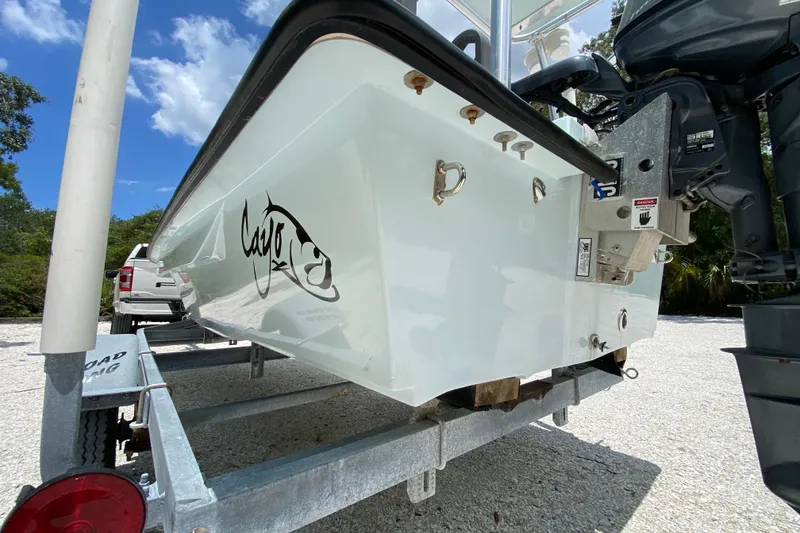 Slide: The Image of 2019 Cayo Boatworks 173 on trailer, featuring sleek design and outboard motor. - 11