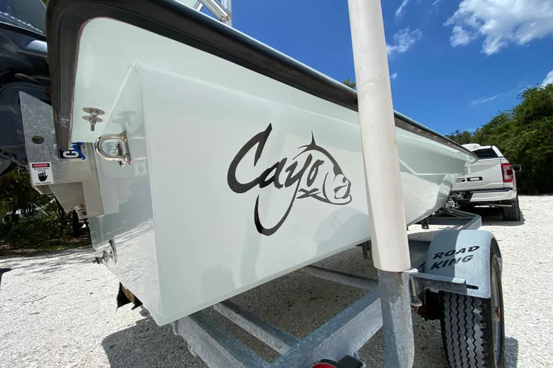Slide: The Image of 2019 Cayo Boatworks 173 on trailer, featuring logo, parked outdoors under blue sky. - 14